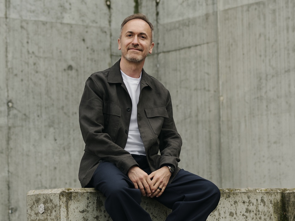 Piotr Mechlinski, seated on a concrete ledge